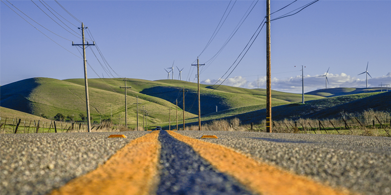 Power lines over a green meadow.